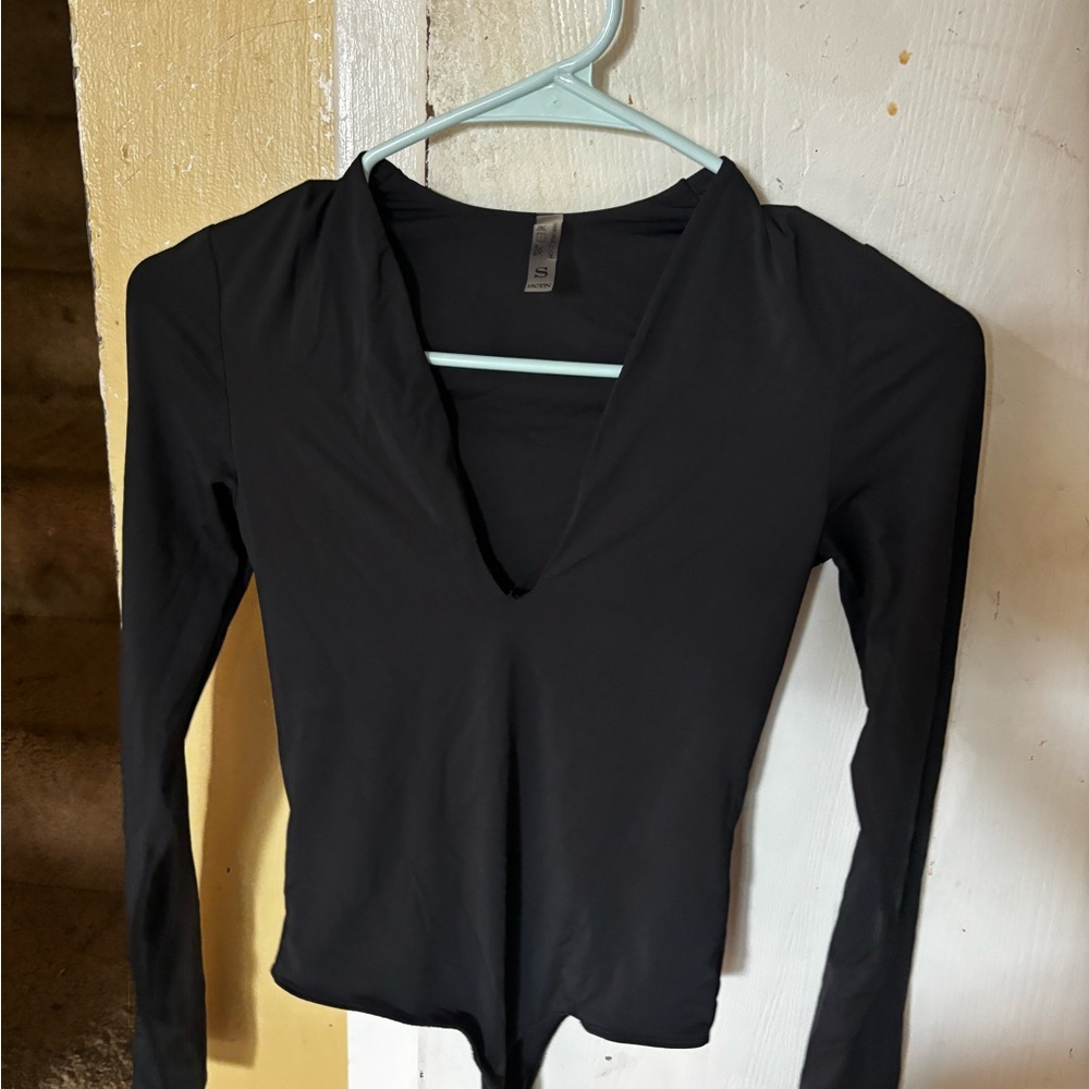 Sleek black fitted body suit